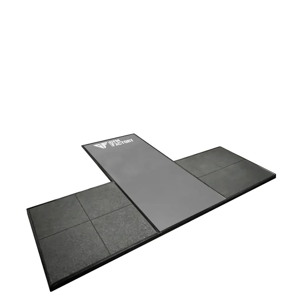 A strength training exercise equipment setup features a deadlifting platform. The platform is installed in a gym setting, surrounded by squat racks and barbells, providing a stable surface for weightlifting exercises.